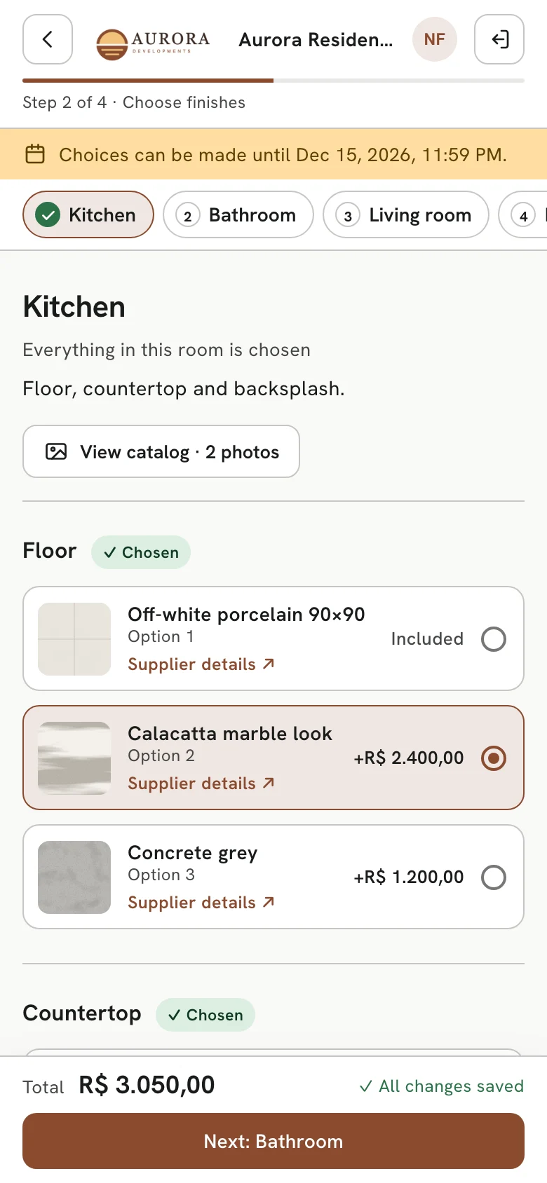A buyer choosing the kitchen floor and countertop on their phone, on the developer's branded website